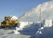 snow-blowers try to keep the road open